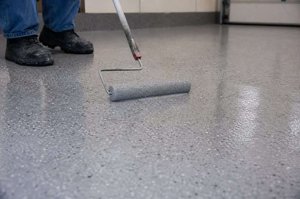 Applying an epoxy garage floor coating with a roller